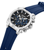 Silver-toned angular watch with black dial, blue subdials, and blue silicone strap. Features a textured crown and pushers.