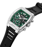 Silver-toned rectangular watch with a green geometric dial, black center, white hands, and three sub-dials, on a black silico