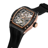 Black and rose gold-toned tonneau watch with a skeleton dial showing silver and gold-toned gears, on a black silicone strap.