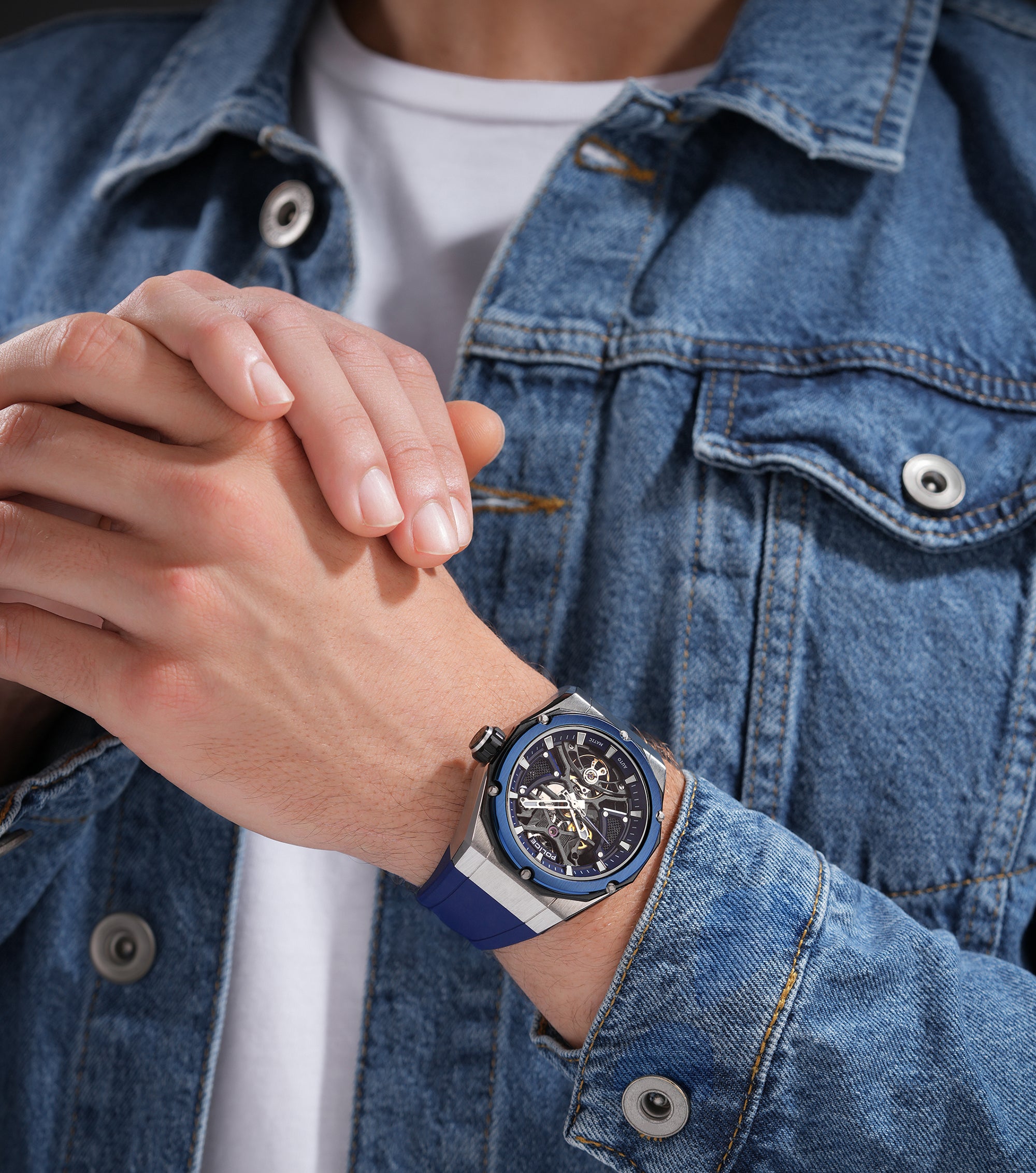 Silver-toned watch with blue octagonal bezel, blue skeleton dial, and blue silicone strap with a white stripe.