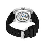 Silver-toned steel watch with a clear case back revealing gears and blue screws, on a black silicone strap with a silver-tone