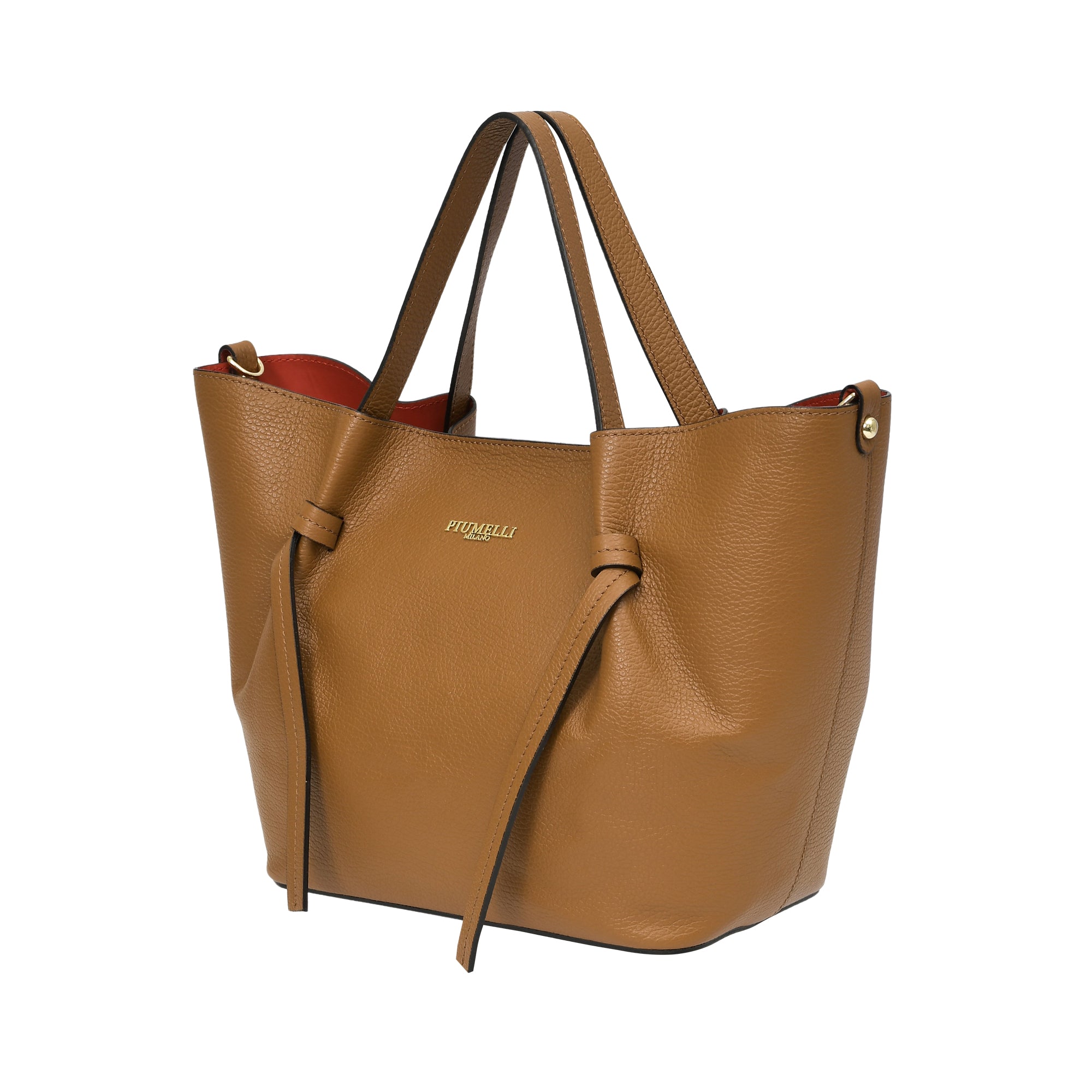 Warm brown pebbled leather tote bag with two top handles, gold-toned logo, decorative side knots, and a red interior lining.
