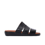Side profile of PRESTIGE black leather slide sandals showing the thick black sole and tan footbed.