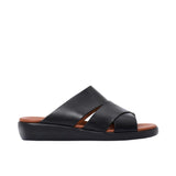 Side profile of a PRESTIGE black leather slide sandal featuring a thick white ergonomic wedge sole and tan footbed.