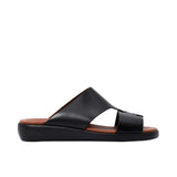 Profile shot of a beige leather Prestige sandal showing the thick black ergonomic sole and cognac brown footbed.
