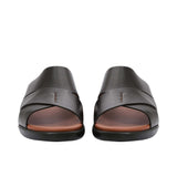 Front-facing view of a pair of brown leather PRESTIGE sandals showing the wide criss-cross straps and open-toe design.