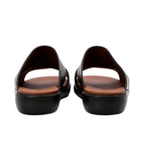 Heel view of PRESTIGE sandals highlighting the "PRESTIGE" branding embossed on the brown of the black wedge sole.