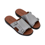 Three-quarter angled view of the PRESTIGE men’s leather slides showcasing the grain of the grey leather and silver hardware.