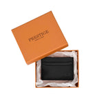 PRESTIGE black leather cardholder inside a premium orange gift box with tissue paper.
