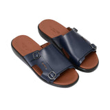 Three-quarter angled view of the PRESTIGE men’s leather slides showcasing the grain of the navy leather and silver hardware.