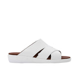 Side profile of a PRESTIGE white leather slide sandal featuring a thick white ergonomic wedge sole and tan footbed.