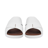 Front-facing view of a pair of white leather PRESTIGE sandals showing the wide criss-cross straps and open-toe design.