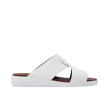 Side profile of a Prestige white leather men's slide sandal showing the thick black sole and tan footbed.
