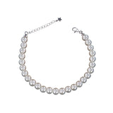 A single strand bracelet featuring numerous round, lustrous white pearls, with a silver-toned lobster clasp and chain extende