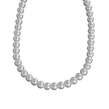 White spherical pearl necklace with a lustrous finish, arranged in a single strand