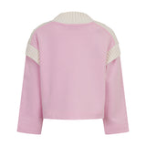Back view of a pink sweatshirt with a cream ribbed stand collar and cream ribbed panels on the upper back and shoulders. Long