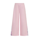 Pink wide-leg jogging pants with ribbed waistband and abstract purple, blue, pink pattern on outer side seams.