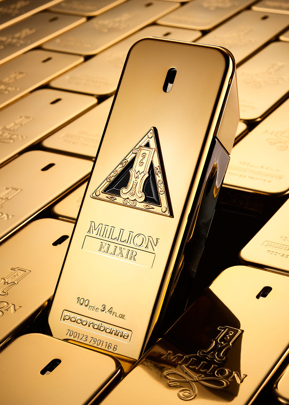 Paco Rabanne 1M Elixir Parfum Intense 100ml Gold bottle labeled 'Million Elixir' on a background of gold bars