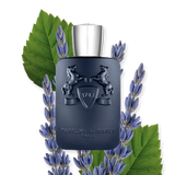 The Layton Eau de Parfum bottle artfully surrounded by sprigs of fresh lavender and green leaves, highlighting the fragrance's aromatic floral notes.