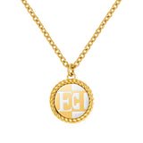 A direct macro shot focusing on the Escada Madelene circular medallion pendant, highlighting the textured twisted rope frame and the alternating gold and white Mother of Pearl quadrant monogram face.