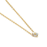 A three-quarter perspective studio shot of the Burj flower motif pendant, showcasing the engraved gold SH monogram disc and the polished cable chain links.