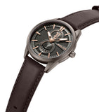 High-angle studio perspective view focusing on the slim brown IP casing profile, the polished crystal face protection, the textured setting crown, and the seamless integration of the stitched brown leather strap.
