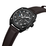 High-angle studio perspective highlighting the honeycomb texture of the black dial, the silver-toned hex screws on the matte black bezel, and the clean edge of the dark brown leather strap.