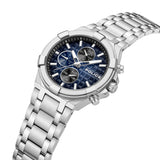 High-angle perspective view of the watch emphasizing the faceted silver bezel, dual pusher buttons, textured crown, and the integration of the steel link bracelet.