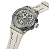 High-angle studio view detailing the transparent properties of the grey TR90 case edges, the white-gripped setting crown, and the deep mechanical layered look of the skeletonized movement face.