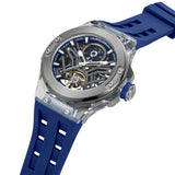 High-angle studio view highlighting the transparency of the integrated TR90 lugs, the blue silicone-ringed crown, and the multi-layered mechanical depth of the open-heart face.