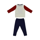 A two-piece Petit Bateau pajama set with a white long-sleeved top featuring red raglan sleeves and a large blue graphic print with a sailboat, paired with solid navy blue trousers.