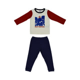 A two-piece Petit Bateau pajama set with a white long-sleeved top featuring red raglan sleeves and a large blue graphic print with a sailboat, paired with solid navy blue trousers.