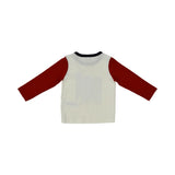 A two-piece Petit Bateau pajama set with a white long-sleeved top featuring red raglan sleeves and a large blue graphic print with a sailboat, paired with solid navy blue trousers.