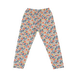 A two-piece Petit Bateau girls' pajama set featuring a short-sleeve top and long pants with a dense coral and blue floral pattern on a white background.