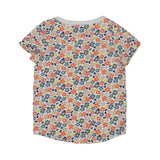 A two-piece Petit Bateau girls' pajama set featuring a short-sleeve top and long pants with a dense coral and blue floral pattern on a white background.