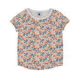 A two-piece Petit Bateau girls' pajama set featuring a short-sleeve top and long pants with a dense coral and blue floral pattern on a white background.