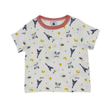Petit Bateau kids' white two-piece pyjama set featuring a blue Eiffel Tower and yellow croissant print with red striped trim.