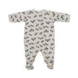 Petit Bateau baby footed onesie in off-white featuring an all-over navy blue zebra print and front snap buttons.