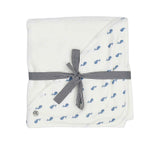 A white square hooded baby towel from Petit Bateau with a corner hood featuring a delicate navy blue whale print.