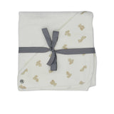 A white square cotton terry baby towel from Petit Bateau featuring a corner hood with a beige teddy bear print.