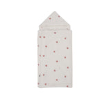 Petit Bateau off-white hooded baby towel with red heart embroidery, folded to show the triangular hood and plush texture.