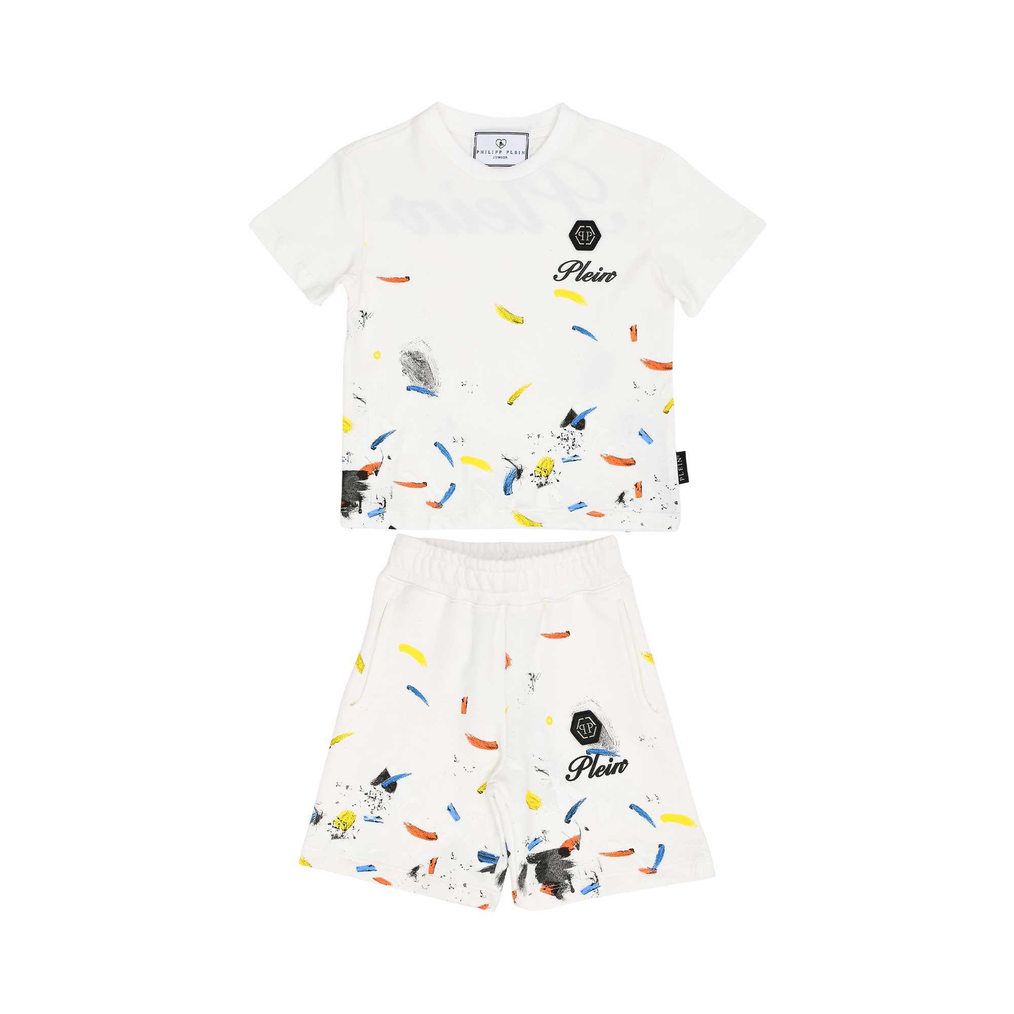 Front view of a white Philipp Plein Junior t-shirt and shorts set featuring a multi-color paint splatter design and black logo branding.
