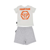 Back view of the Philipp Plein Junior set, highlighting the large orange spray-effect brand logo and hexagonal motif on the t-shirt.