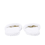 The open toe openings of a pair of white terry slippers, revealing the padded interior and the repeating logo design.