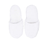 A direct top-down view of a pair of white Philipp Plein terry slippers, displaying the hexagonal monogram on the insole and upper.
