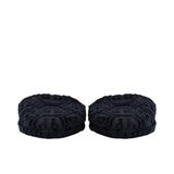 A close-up view focusing on the padded front parts of a pair of black terry slippers, clearly showing the intricate hexagonal PP logo pattern.