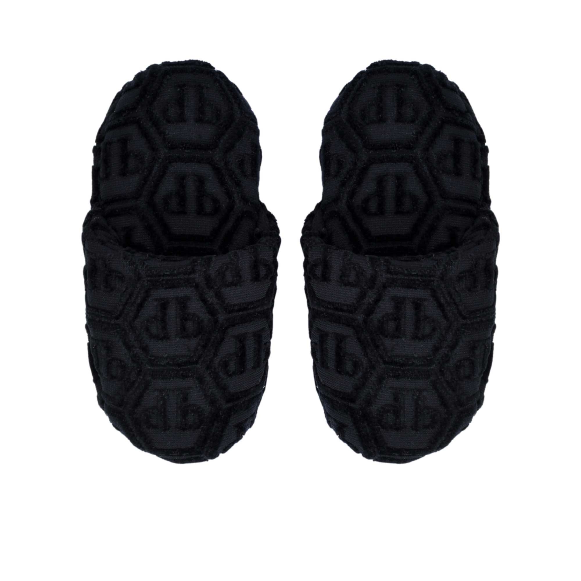 A direct top-down view of a pair of black Philipp Plein terry slippers, displaying the hexagonal monogram on the insole and upper.