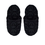 A direct top-down view of a pair of black Philipp Plein terry slippers, displaying the hexagonal monogram on the insole and upper.