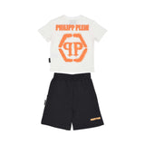 Back view of the Philipp Plein Junior set, highlighting the large orange spray-effect hexagonal logo on the t-shirt and script branding on the shorts.