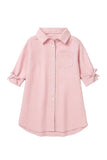 Pink collared shirt dress with three-quarter sleeves, bow details on cuffs, button-front, and a single chest pocket.